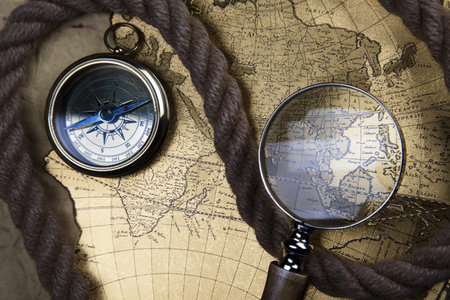 Antique brass compass over old map