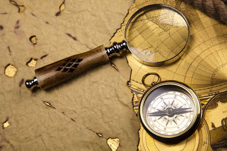 Antique brass compass over old mapの写真素材