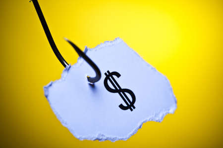 Dollar sign on piece of paper on hookの写真素材