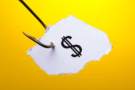 Dollar sign on piece of paper on hookの写真素材