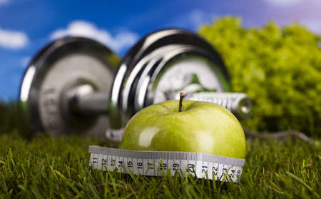 Apple with measuring of dumbbellの写真素材