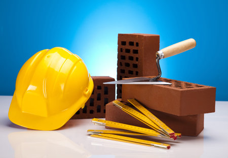 Brick, yellow hard hat, tools