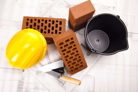 Hard hat with bricks and trowelの写真素材