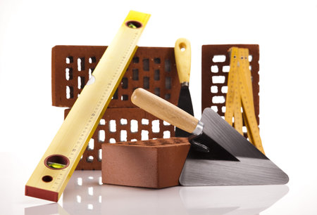Hard hat with bricks and trowel