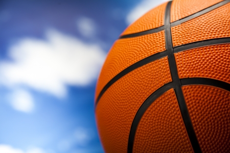 Basketball ball over blue sky background の写真素材
