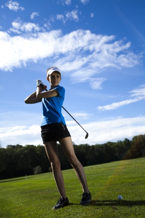 Girl playing golf の写真素材