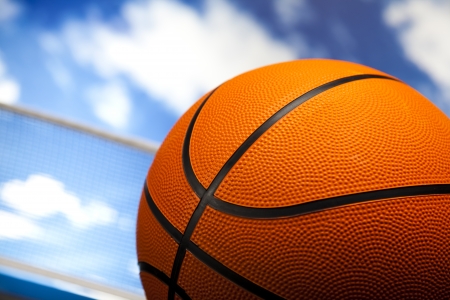 Basketball ball over blue sky background の写真素材