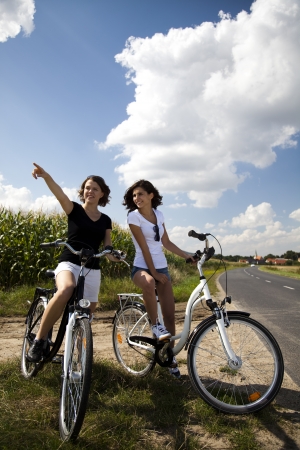 Young girls riding a bicycle の写真素材