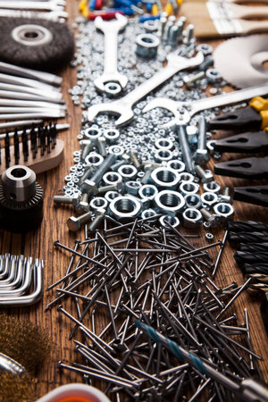 Assorted work tools on wood background