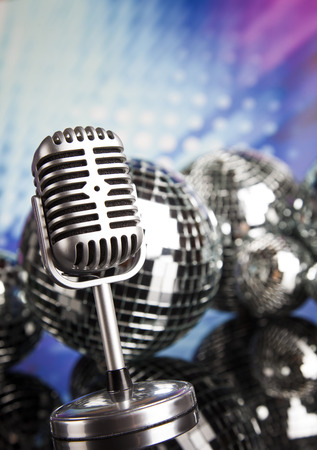 Retro style microphone on sound waves and Disco Ballsの写真素材