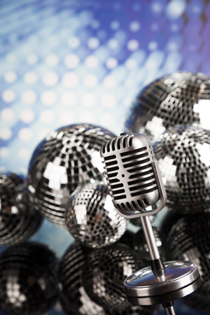 Retro style microphone on sound waves and Disco Ballsの写真素材