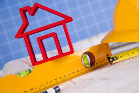 House under construction, blueprints and helmetの写真素材