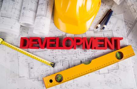 Hard hat with blueprints and rulersの写真素材