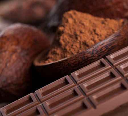 Aromatic cocoa and chocolate on wooden backgroundの写真素材