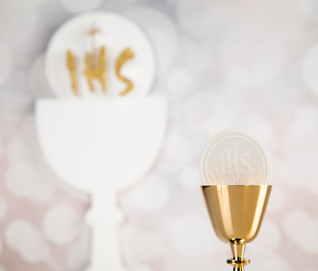 Holy communion a golden chalice, composition isolated on white