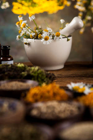 Natural medicine, herbs, mortar on wooden table backgroundの写真素材