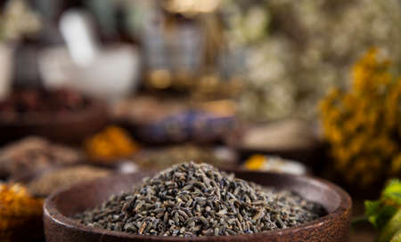 Healing herbs on wooden table, mortar and herbal medicineの写真素材