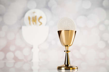Holy communion a golden chalice, composition isolated on whiteの写真素材
