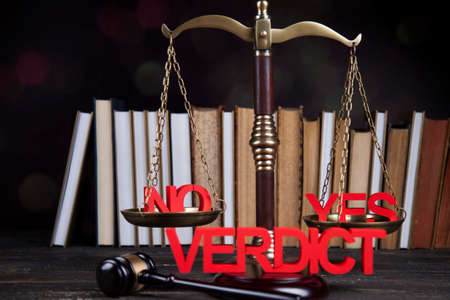 Law theme, mallet of the judge, justice scale, wooden desk backgroundの写真素材