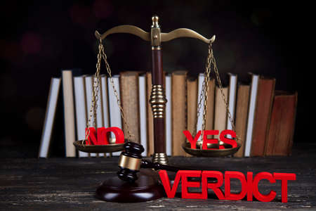 Law theme, mallet of the judge, justice scale, wooden desk backgroundの写真素材