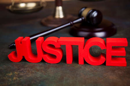 Judges wooden gavel, on wooden table backgroundの写真素材