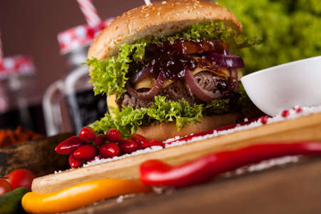 Close-up of home made burgers, wooden desk backgroundの写真素材