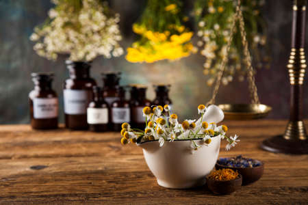 Natural medicine, herbs, mortar on wooden table backgroundの写真素材