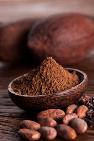 Cocoa beans in the dry cocoa pod fruit on wooden backgroundの写真素材