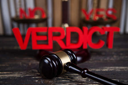 Law theme, mallet of the judge, justice scale, wooden desk backgroundの写真素材