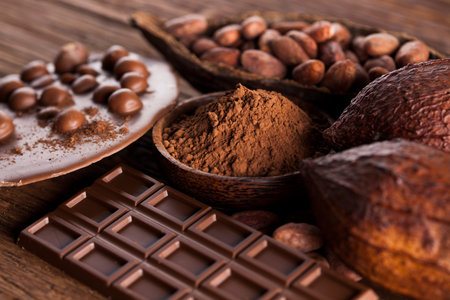 Aromatic cocoa and chocolate on wooden background