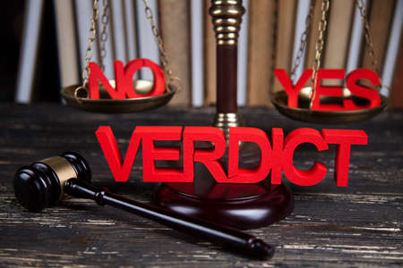 Law theme, mallet of the judge, justice scale, wooden desk backgroundの写真素材