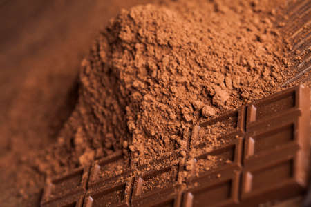 Dark homemade chocolate bars and cocoa pod on woodenの写真素材