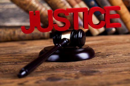 Judges wooden gavel, on wooden table backgroundの写真素材