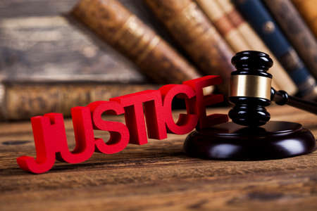 Judges wooden gavel, on wooden table backgroundの写真素材