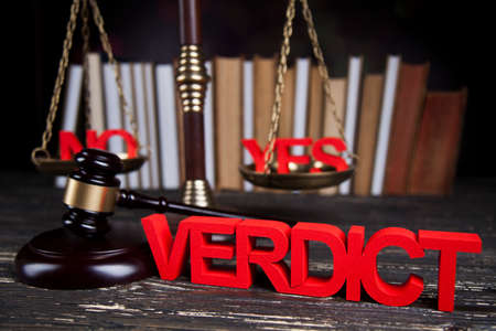 Law theme, mallet of the judge, justice scale, wooden desk backgroundの写真素材