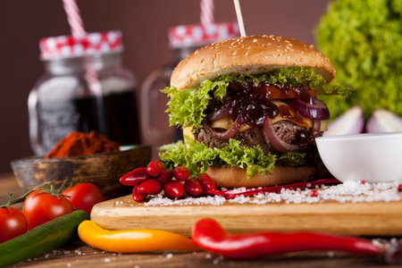 Close-up of home made burgers, wooden desk backgroundの写真素材