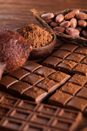 Milk and dark chocolate on a wooden table
