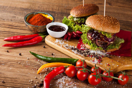 Close-up of home made burgers, wooden desk backgroundの写真素材