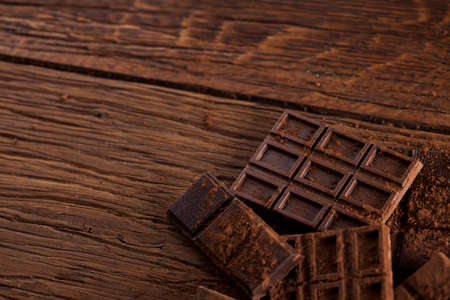 Dark and milk chocolate bar on a wooden tableの写真素材