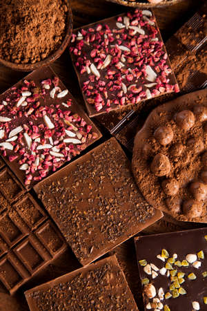 Dark homemade chocolate bars and cocoa pod on woodenの写真素材