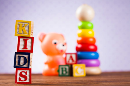 Colorful children toys on wooden backgroundの写真素材