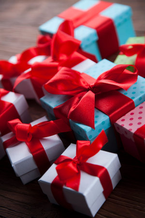 Gift boxes with red ribbon on Christmas background