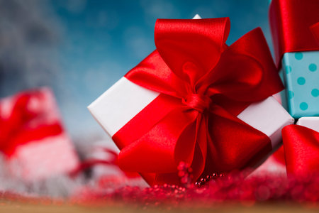 Gift boxes with red ribbon on Christmas backgroundの写真素材