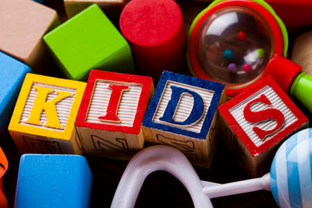 Colorful children toys on wooden backgroundの写真素材