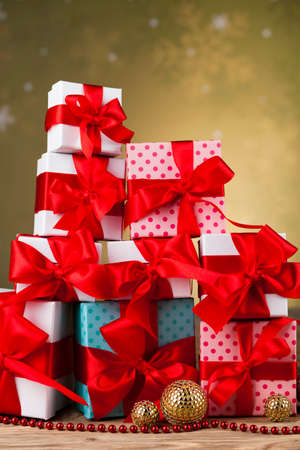 Gift boxes with red ribbon on Christmas backgroundの写真素材