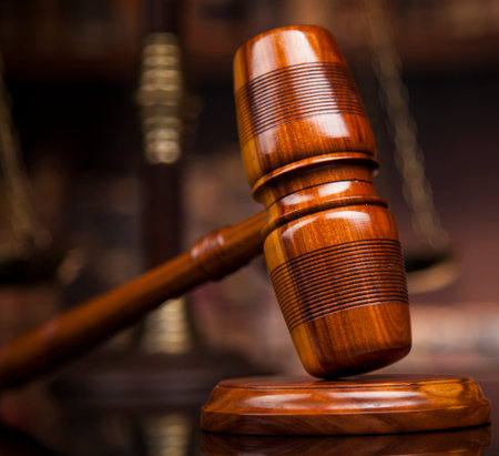 Judge gavel and scales of justice and book background