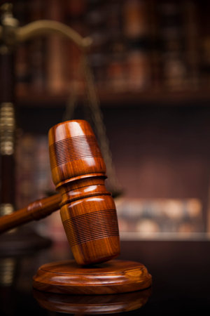 Judge gavel and scales of justice and book background