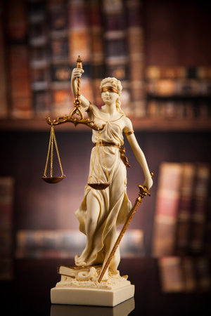 Judge gavel and scales of justice and book background