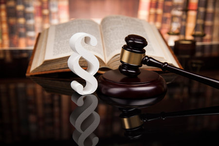 Judge gavel and scales of justice and book background