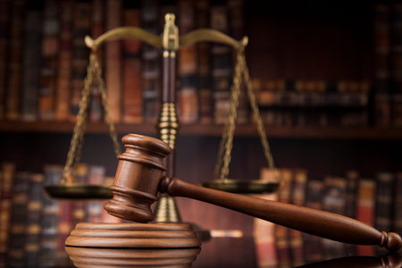 Law theme, mallet of the judge, wooden desk, books
